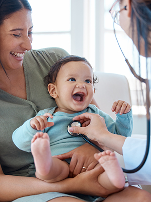 baby laughing at a doctor