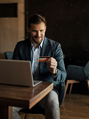 man buying something online looking at his card