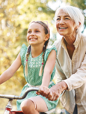 grandmother and granddaughter riding a bike