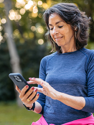 A lady sitting outside on her phone. 