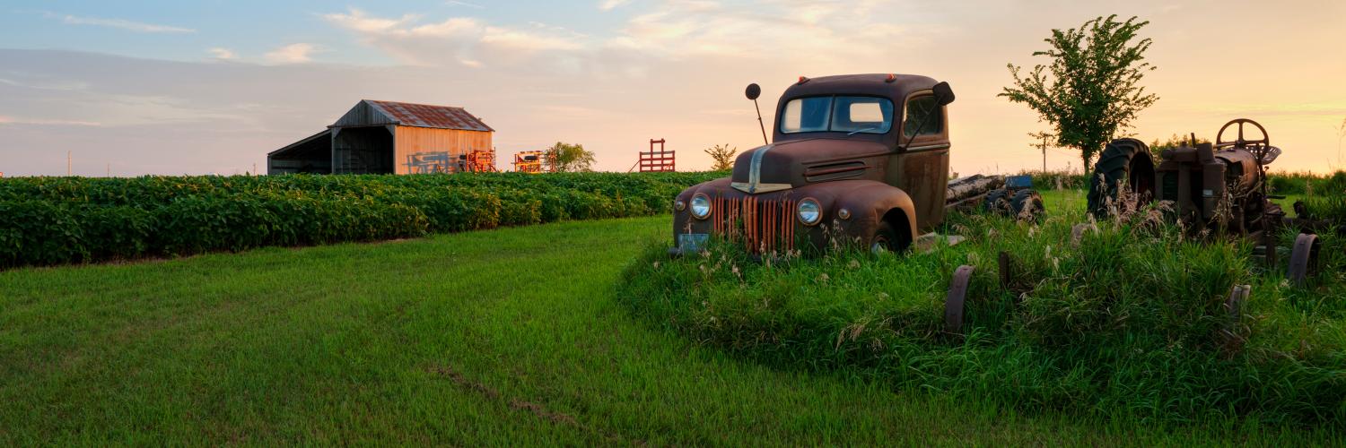 rural farm scene with a rusty pickup