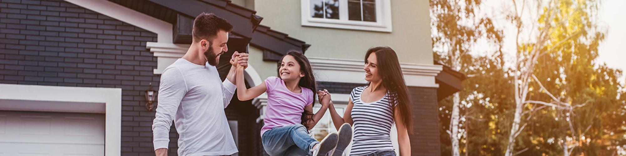 family in front of a house