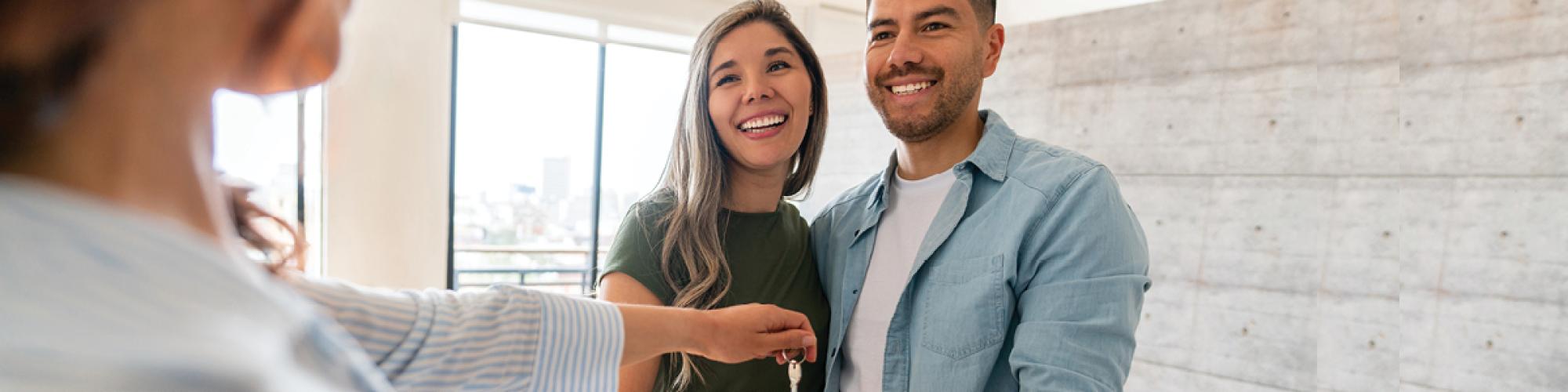 couple getting keys to their new house