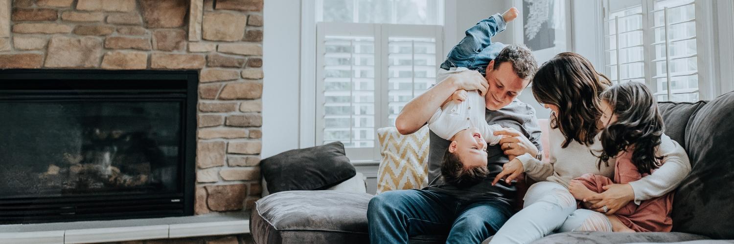 Family laughing on the couch
