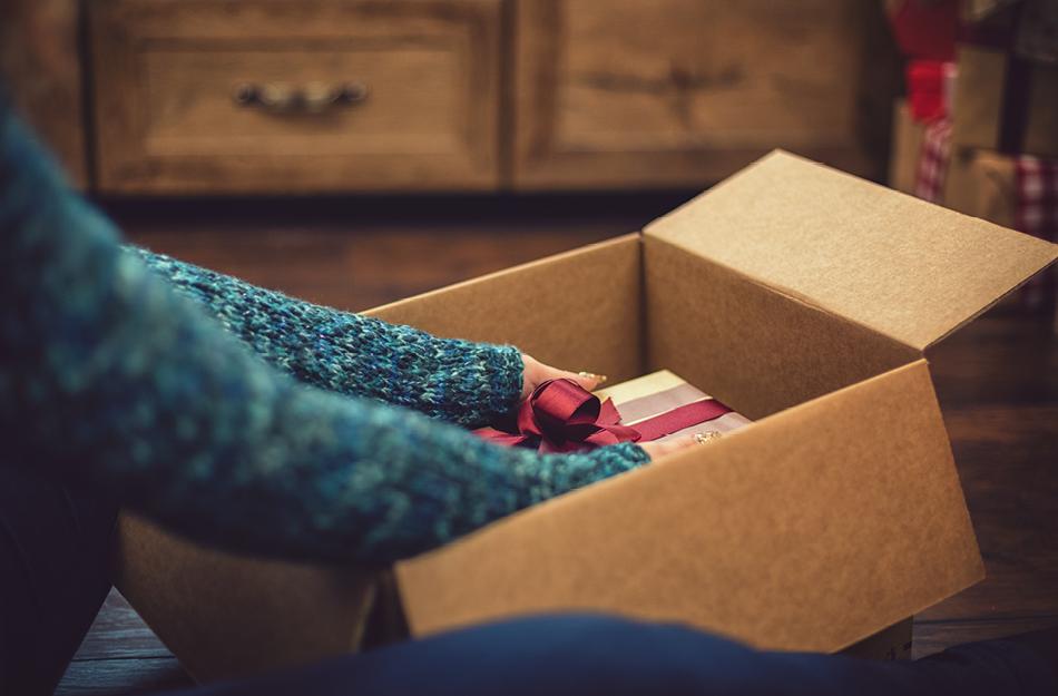 someone opening a box receiving a present