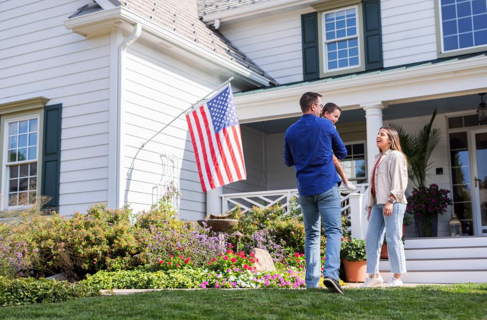 family in front of their new home