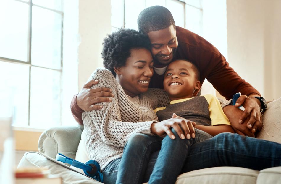 Family laughing on the couch