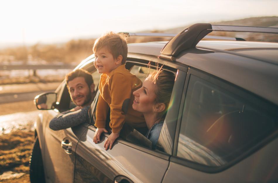 a family looking out the window of their car