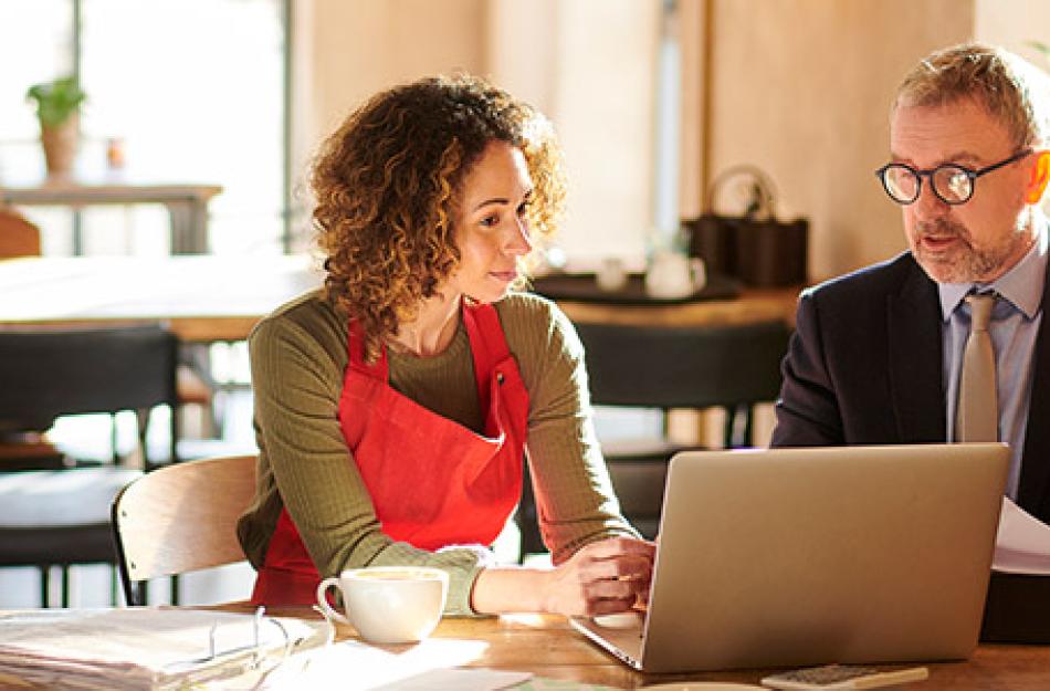 man and woman looking at a laptop