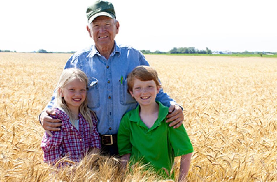 farmer and kids in a field