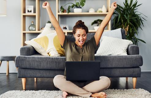 woman excited about something on her computer