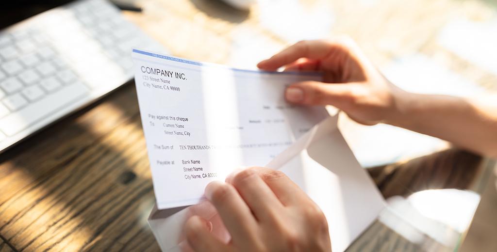 Check being taken out of an envelope.