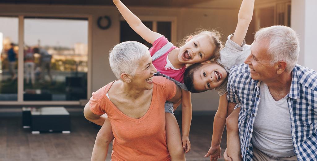 grandparents laughing with their grandkids