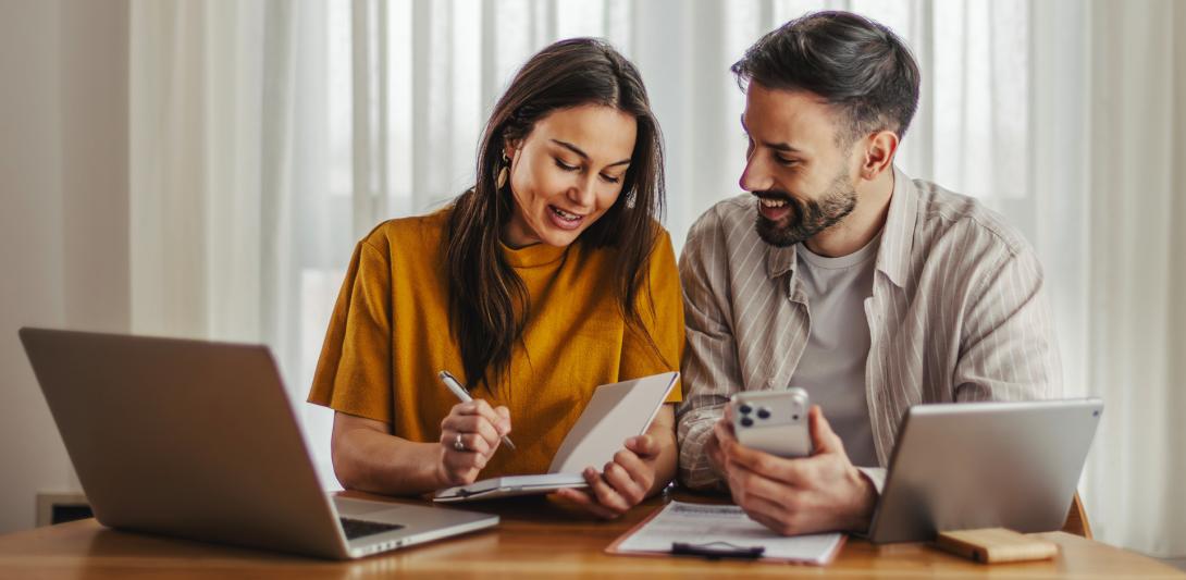 man and woman looking at a computer